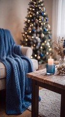 Fototapeta premium A cozy decorated living room interior with a glowing Christmas tree near a sofa draped with a blue throw blanket and a rustic wooden coffee table with candle