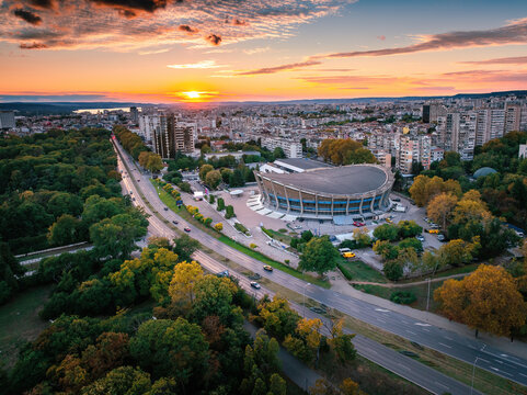 Aerial view of Palace of Culture and Sports and Varna cityscape at golden hour sunset