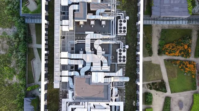 Rooftop of modern office building HVAC system with intricate ductwork and air conditioning units, showcasing the layout and design of mechanical components in a commercial setting. Aerial view