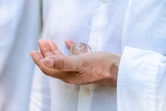 Close-up of a clear crystal resting in an open hand during a spiritual healing and guided meditation practice focused on mindfulness, energy balance, and emotional wellbeing.