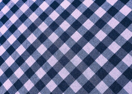 Black and white gingham fabric texture, checkered vichy pattern background close up.