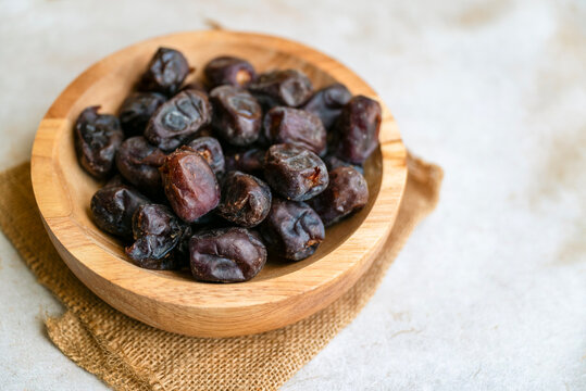 Dry dates in wooden  bowl