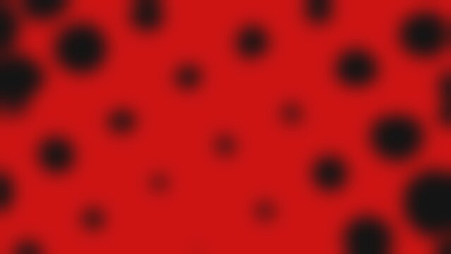 Red background with bold black circular spots. Pattern repeats evenly across the surface