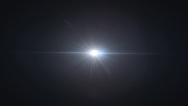 A bright sun with intense rays causing a lens flare effect against a dark sky