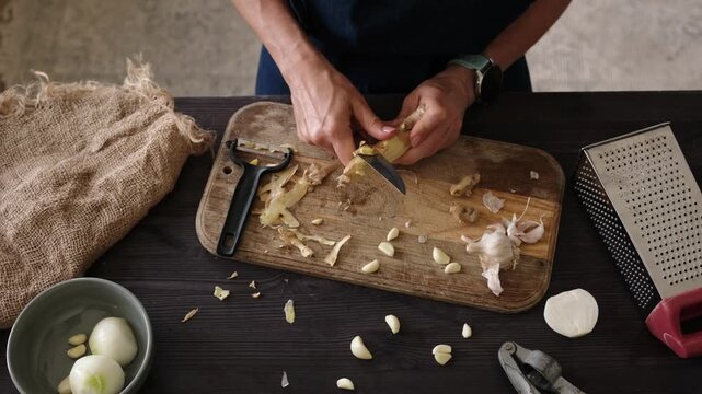 Close-Up Top View Of A Woman Peeling Ginger