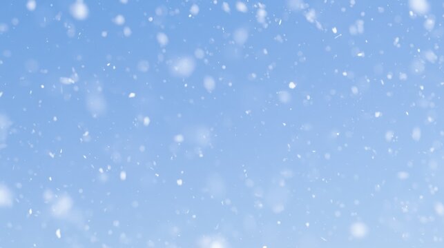 Snow falls in a clear blue sky over a winter landscape during a cold day in a rural area