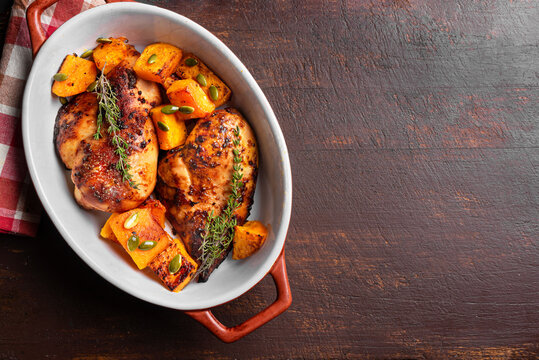 Autumn meal: roasted chicken breast and pumpkin with herbs