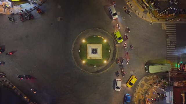 Aerial view of Tugu Yogyakarta Monument illuminated at night with traffic flowing around the roundabout in Yogyakarta, Special Region of Yogyakarta, Indonesia.