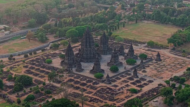 Aerial view of the historic Prambanan Temple complex featuring towering stone spires and surrounding ruins amidst lush greenery in Yogyakarta, Special Region of Yogyakarta, Indonesia.