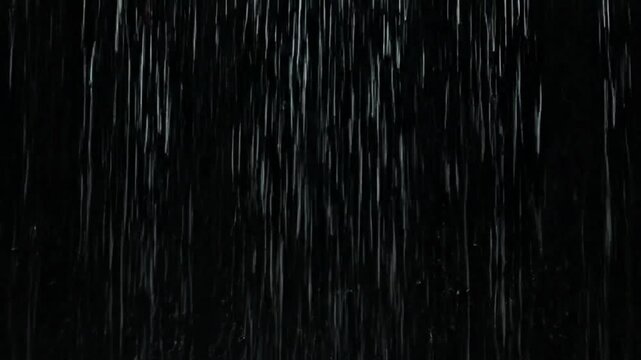 Heavy rainstorm with intense vertical streaks on dark background