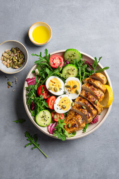 High protein lunch bowl with chicken, eggs and vegetable salad