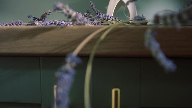 Lavender flowers and oil burner on home green cabinet