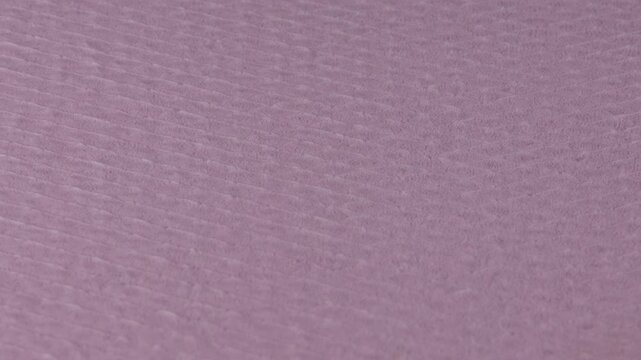 Textured Extruded Polystyrene Insulation Surface 
Close-up footage of extruded polystyrene insulation with a clearly textured and slightly rough surface, showing relief, pattern and rigid foam structu