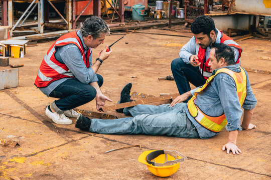 Injured Worker Construction Site Accident Colleagues Helping Emergency Call Walkie Talkie