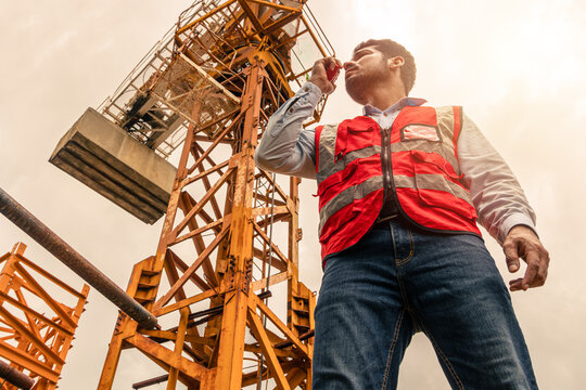 Indian construction engineer worker Tower Crane control operation. Foreman operate Tower crane.