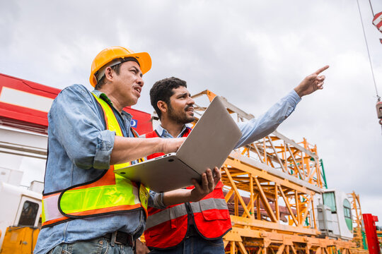 Two Engineers Professional Worker Control Operate Crane in Construction Site Building Development