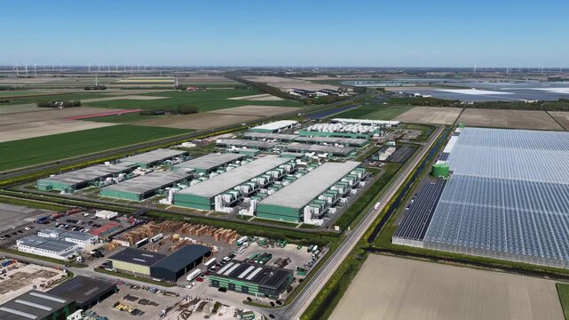 Aerial view of a large data center campus surrounded by green fields