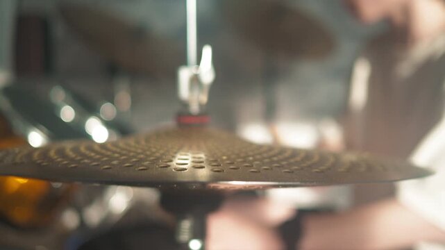 Drummer playing in a band, showing focus and skill during a rehearsal in a studio