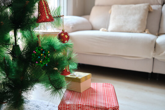 Decorated christmas tree with presents in living room