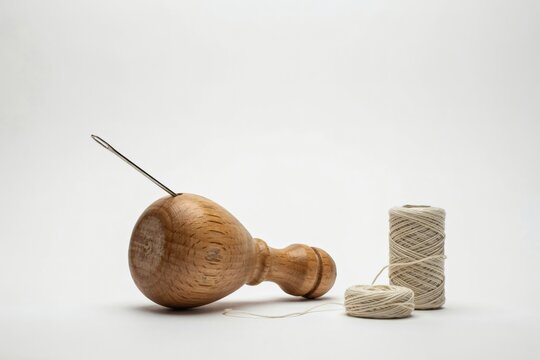 Sailmaker's palm and waxed thread for hand stitching canvas