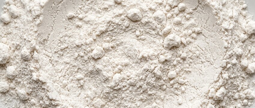 White tapioca starch powder texture overhead view. Close-up of fine cassava flour with small clumps