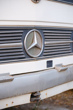 Iconic three pointed star emblem on the radiator grille of a vintage Mercedes-Benz bus showcasing classic automotive design
