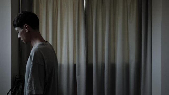 Worried man pacing at home while overthinking difficult problem