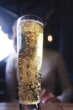 Close-Up of Sparkling Wine in Tall Glass with Bubbles and Lime Slice in Elegant Setting