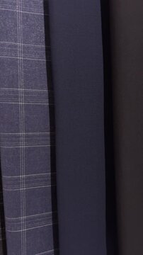 Vertical shot of premium pinstripe suit fabrics as camera tracks