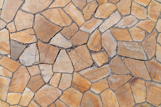 Irregular flagstone paving creating mosaic pattern on outdoor ground