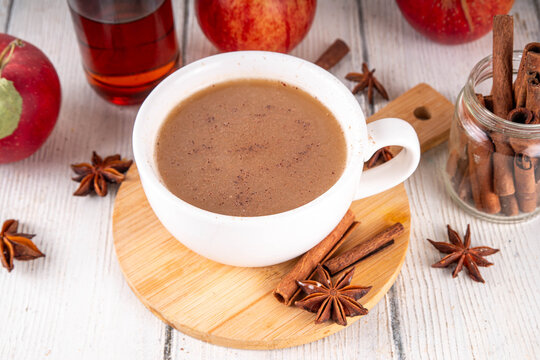 Sweet autumn apple spice coffee latte, warm autumn drink with strong coffee, creamer, fall spices - cinnamon, nutmeg, ginger, cloves, tasty cozy warming beverage