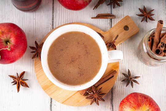 Sweet autumn apple spice coffee latte, warm autumn drink with strong coffee, creamer, fall spices - cinnamon, nutmeg, ginger, cloves, tasty cozy warming beverage
