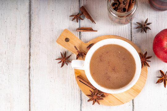 Sweet autumn apple spice coffee latte, warm autumn drink with strong coffee, creamer, fall spices - cinnamon, nutmeg, ginger, cloves, tasty cozy warming beverage