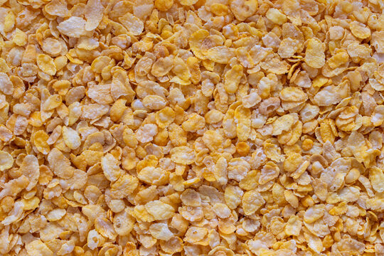 Crispy yellow corn flakes texture background for healthy breakfast design