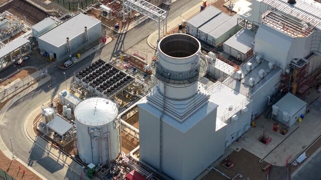 Aerial view of the Rookery South ERF and Millbrook Power plant complex featuring industrial infrastructure, chimneys, tanks, and cooling systems in Stewartby, England, United Kingdom.