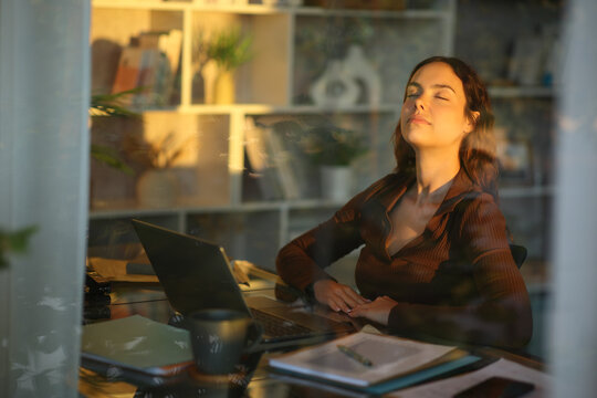 Young telecommuter relaxing and breathing at home