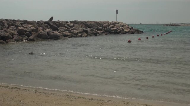 Beach breakwater rock buoy coast Cunit Mediterranean sky sunlight sand