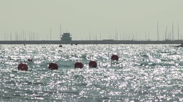 Ocean sea buoy backlight port masts coast Cunit Mediterranean sky waves