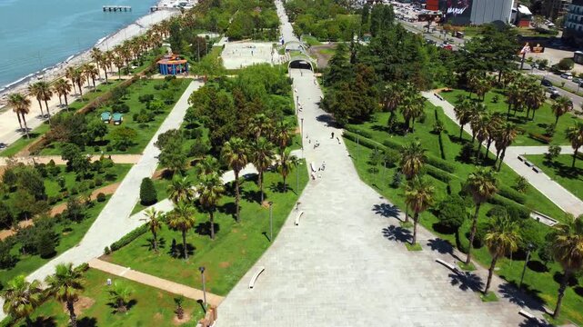 Aerial drone view capturing the expansive lech and maria kaczynski park in batumi, showcasing its modern design, green spaces, and proximity to the beautiful black sea coastline