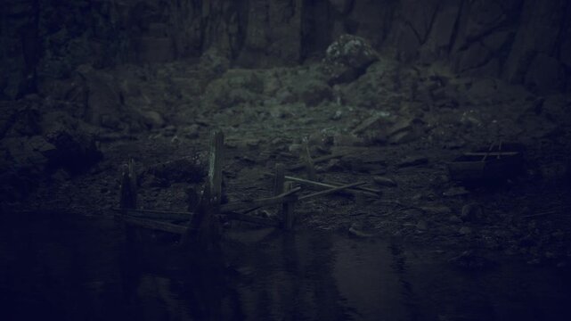 Mossy forest floor with still pond and abandoned wooden chairs, shadowed rock walls draped in thick green moss, faint mist hugging water surface, damp texture,
