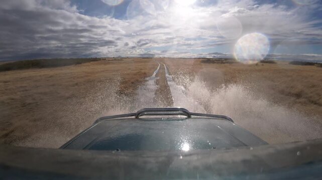 Dark Off Road Vehicle Splashing Through Muddy Track in Slow Motion