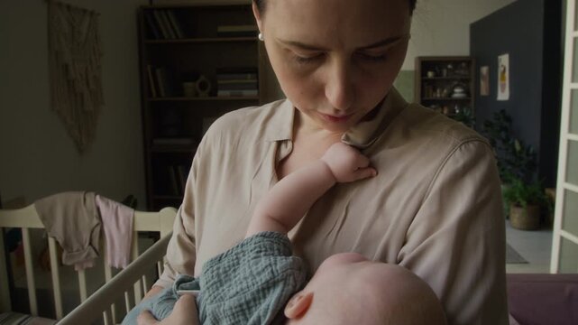 Caucasian young adult mother gently rocking sleeping baby in arms. Visual suitable for parenting marketing, maternal healthcare projects, and pediatric wellness commercials