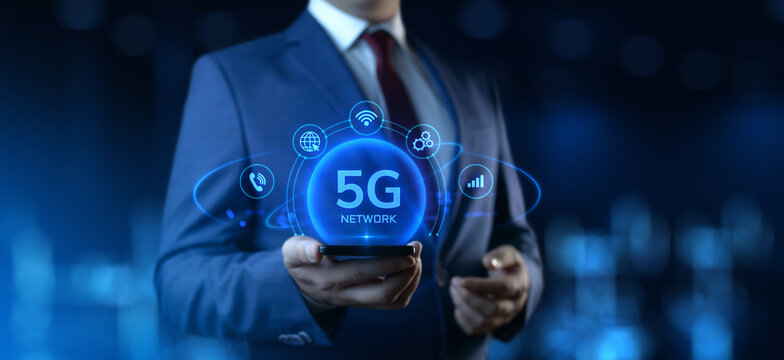 Businessman Holding Smartphone with 5G Network Icons on Screen. Business and Technology concept