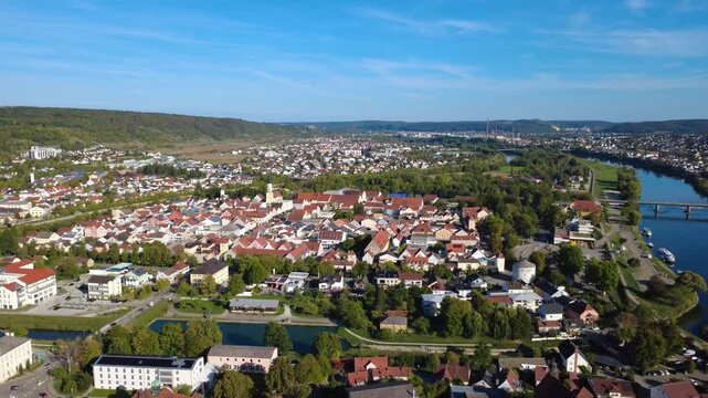 Aerial orbit over Kelheim with the Danube River, historic town, residential areas and industrial facilities in Bavaria, Germany