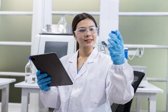Laboratory technician conducts experiments with test tubes in a modern research facility
