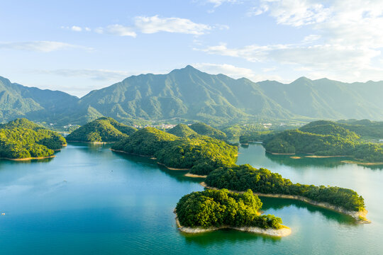 Aerial view of lush green islands in the blue waters of qiandao lake surrounded by mountains