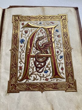 Medieval illuminated manuscript page with letter A and dragon