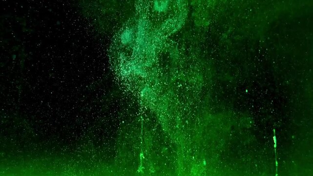 Vibrant green ink swirling and dispersing in dark water creating mesmerizing abstract patterns