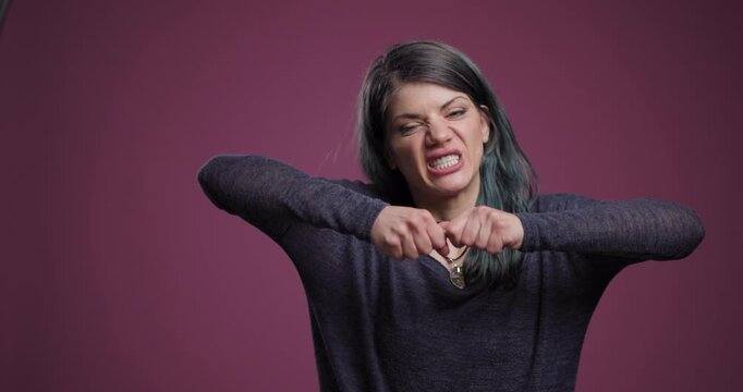 Woman struggling to stretch a pen with an expression of effort and concentration