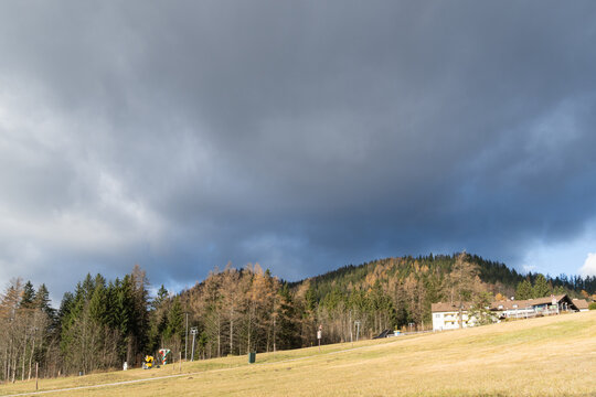 Ski slope with forested mountain and lift infrastructure